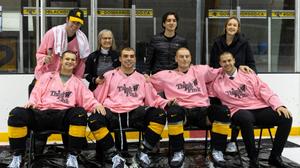 Four mens hockey players pose after shaving their heads for the Warriors Think Pink campaign 