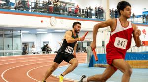 Waterloo Warriors track & field athlete running track with ballot in hand 