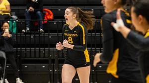 Womens volleyball player Avery Kelly cheering after their team scored a point