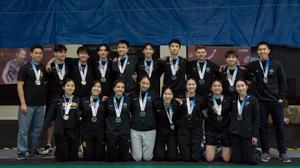 Badminton team posing for photo with silver medals 